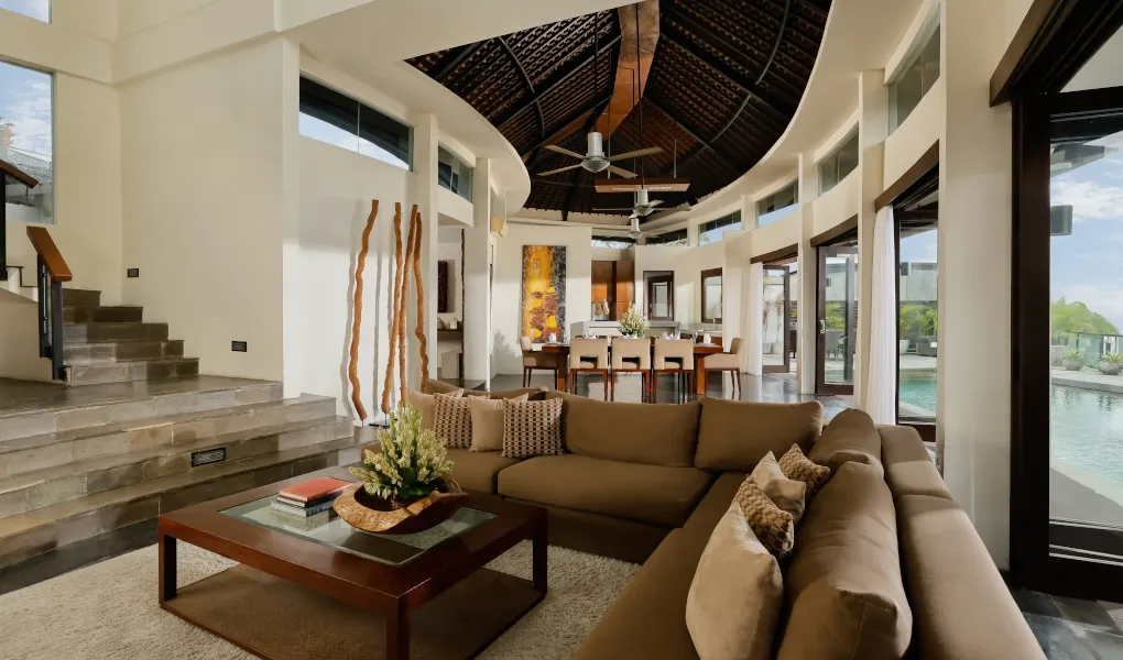 Luxurious villa living room with high ceilings and a curved staircase at Villa Oshra