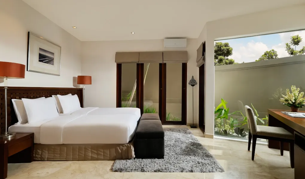 Minimalist bedroom with a large bed and a desk by the window at Villa Oshra