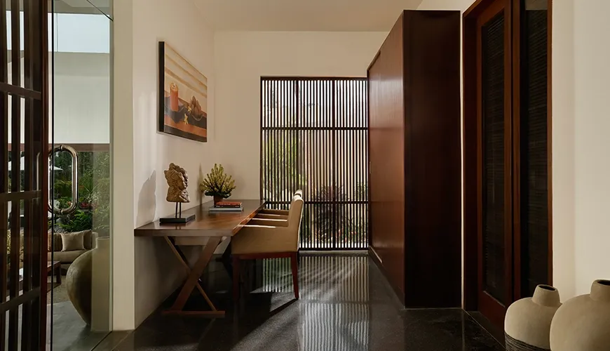 Modern and minimalist home office area with a sleek wooden desk and elegant interior design at Villa Oshra