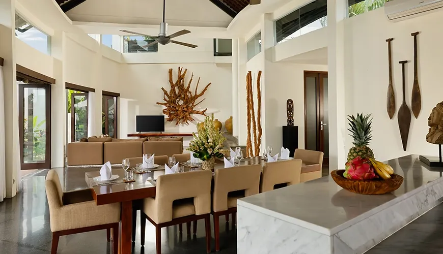 Modern dining area with large table and abstract wall art at Villa Oshra