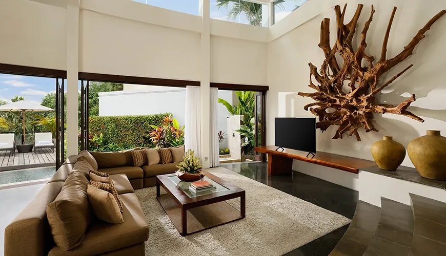Modern living area with large sofa and unique wooden art at Villa Oshra