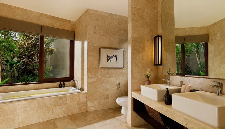 Spacious bathroom with large bathtub double vanity and garden views at Villa Oshra