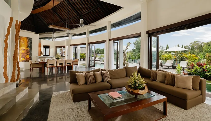 Spacious open living dining area with high ceilings and art at Villa Oshra