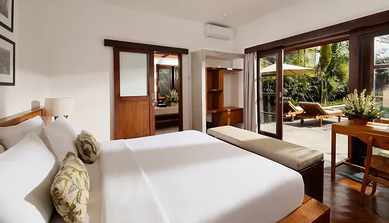 Luxurious bedroom with a garden view and outdoor access at Villa Perere9