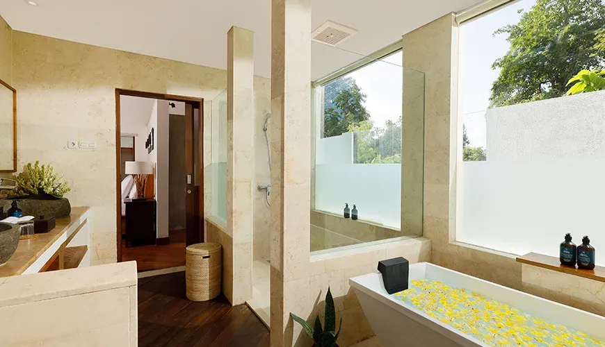 Serene bathroom featuring a soaking tub and stone accents at Villa Perere9