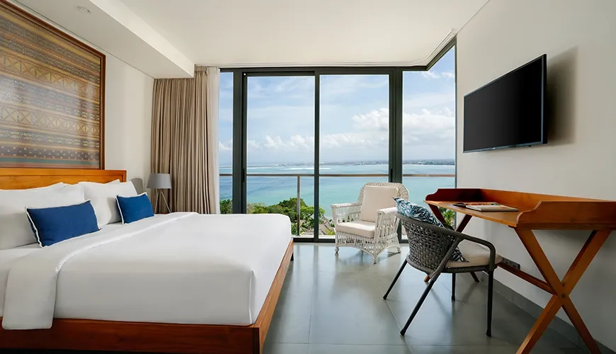 Comfortable bedroom with a large bed, featuring a stunning ocean view from the floor-to-ceiling windows at Villa Santos Cliff View