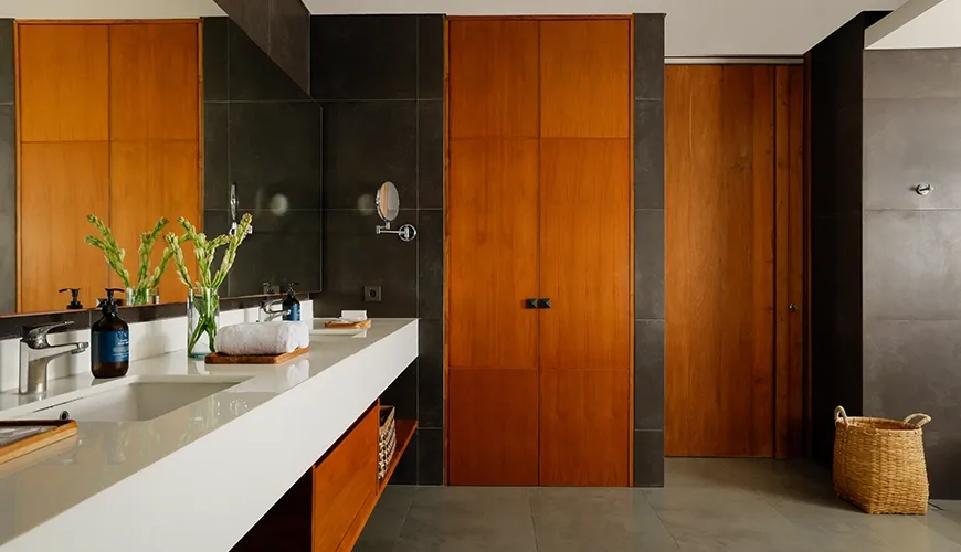 Luxurious and spacious modern bathroom with a double sink vanity and stylish wood cabinetry at Villa Santos Cliff View