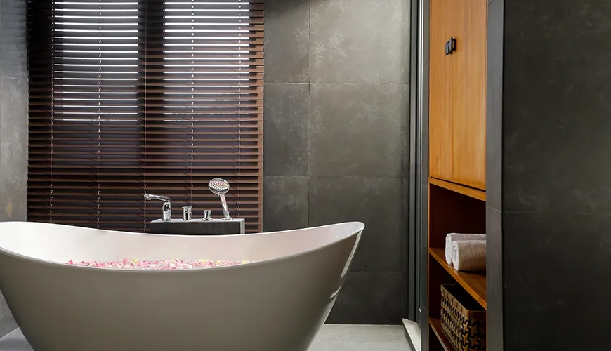 Luxurious bathroom featuring a modern free-standing bathtub filled with fresh rose petals for a relaxing spa experience at Villa Santos Cliff View