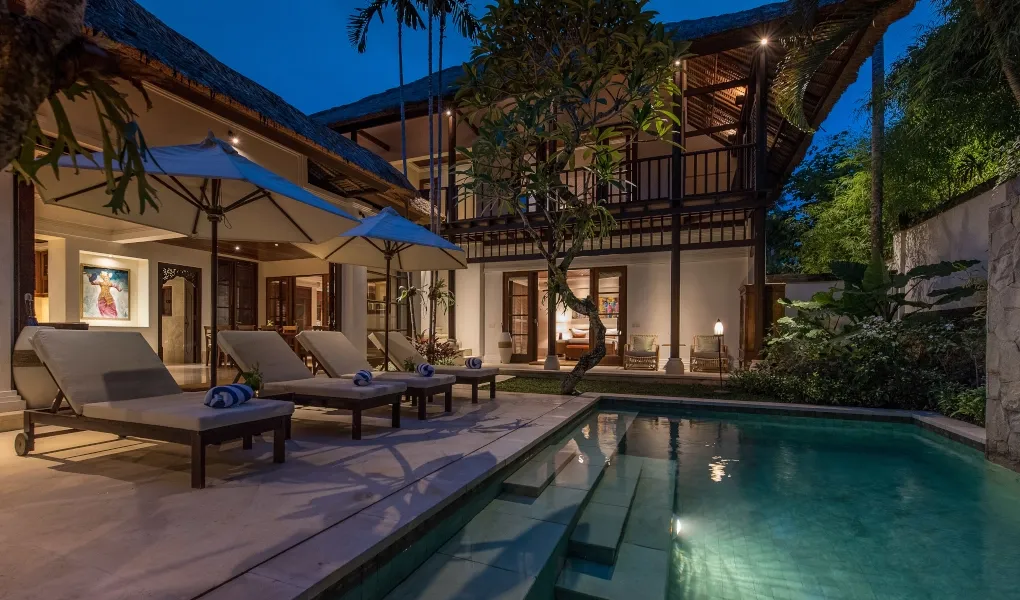 Bali villa exterior at night with illuminated pool at Villa Senada