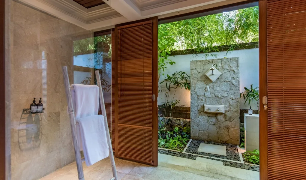Balinese bathroom with outdoor shower and tropical plants at Villa Senada