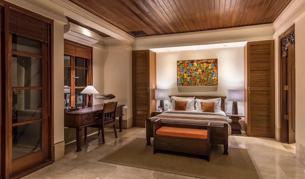 Balinese bedroom with wooden furniture and desk area at Villa Senada
