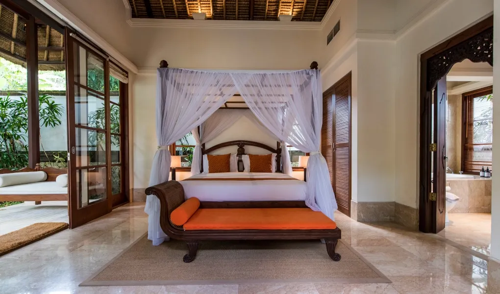 Elegant Balinese pavilion room with canopy bed and garden view at Villa Senada