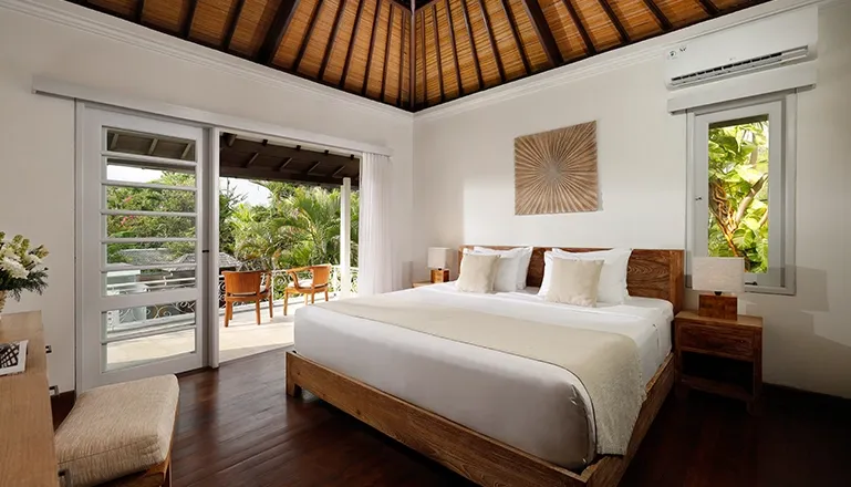 Bedroom king bed balcony tropical view thatched roof ceiling at Villa Swarna