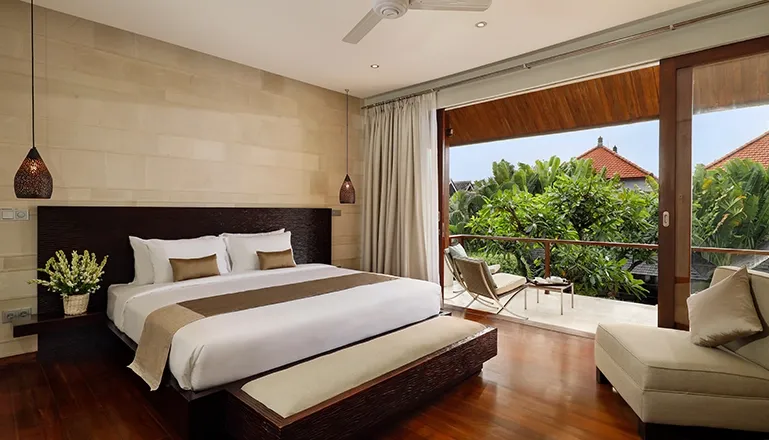 Bedroom king bed balcony lush tropical view at Villa Tenang
