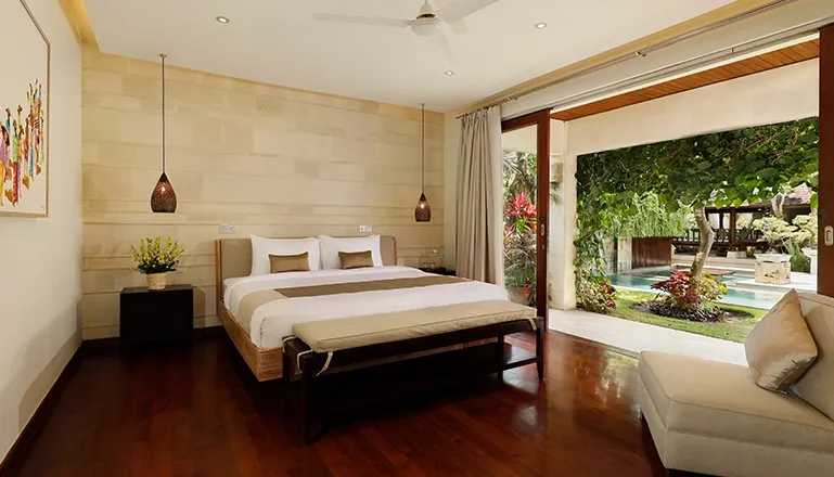 Bedroom king bed open to tropical garden pool at Villa Tenang