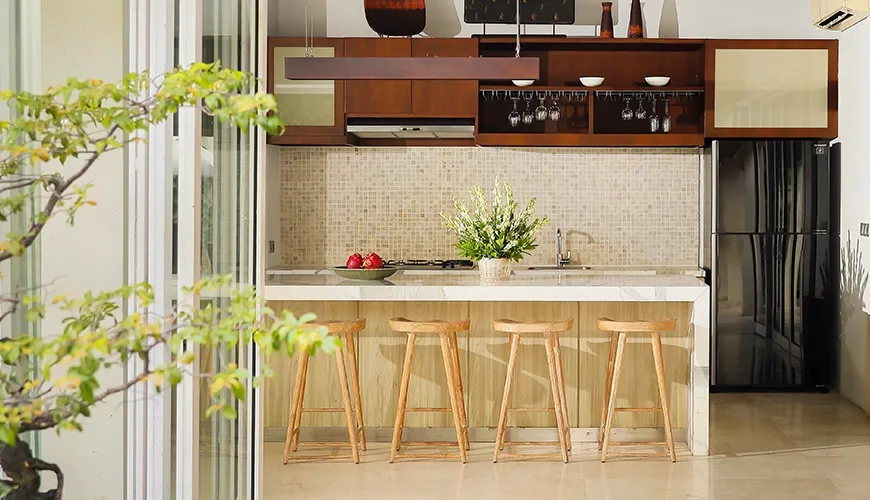 Modern villa kitchen island bar stools stone backsplash at Villa Tenang