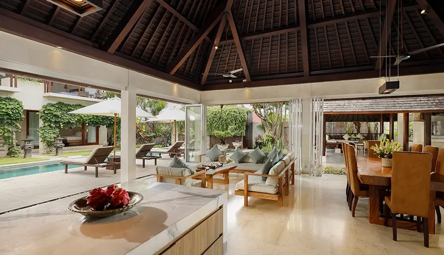 Open villa living room with pool and dining views at Villa Tenang