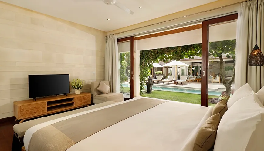 Spacious bedroom TV poolside view lush greenery at Villa Tenang