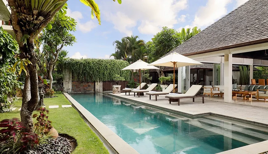 Villa pool deck sun loungers green tropical garden at Villa Tenang
