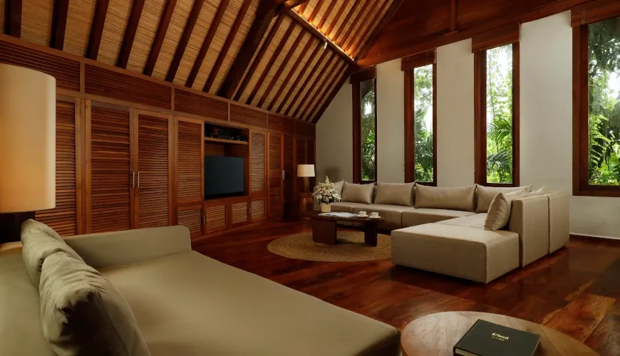 Cozy living room with plush sofas, vaulted ceilings, and large windows at Villa Tirtadari