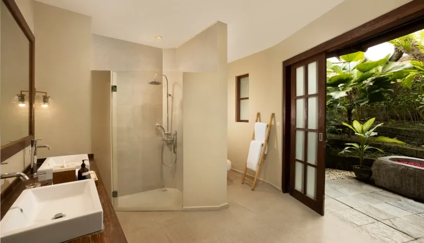 Spacious bathroom with dual sinks and an indoor-outdoor feel at Villa Tirtadari