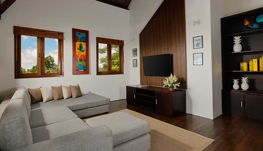 Comfortable villa media room featuring a large sectional sofa big screen television and high vaulted ceiling at Villa Tropical Svasti