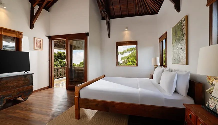 Stunning villa bedroom featuring exposed wooden rafters comfortable king bed and beautiful view from the private balcony at Villa Tropical Svasti