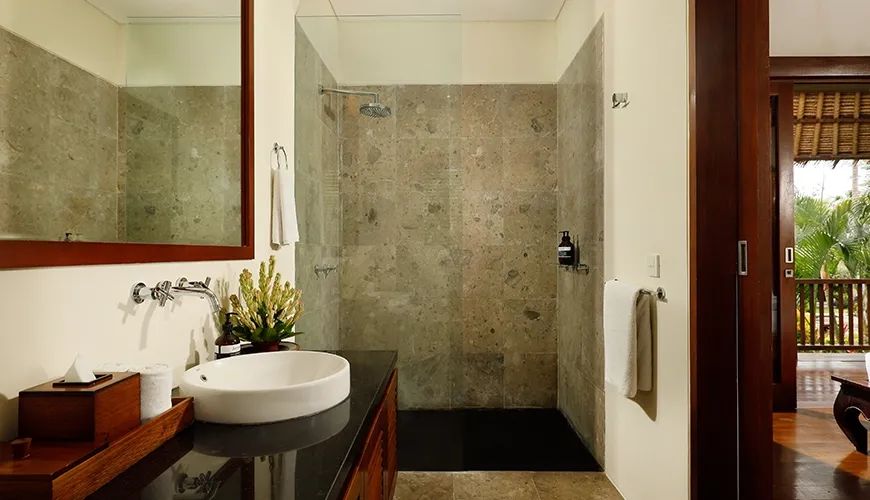 Elegant villa bathroom featuring a vessel sink, spacious walk-in shower, and natural light wood trim at Villa Uma Nina