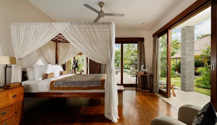 Spacious master bedroom with pool view at Villa Uma Nina