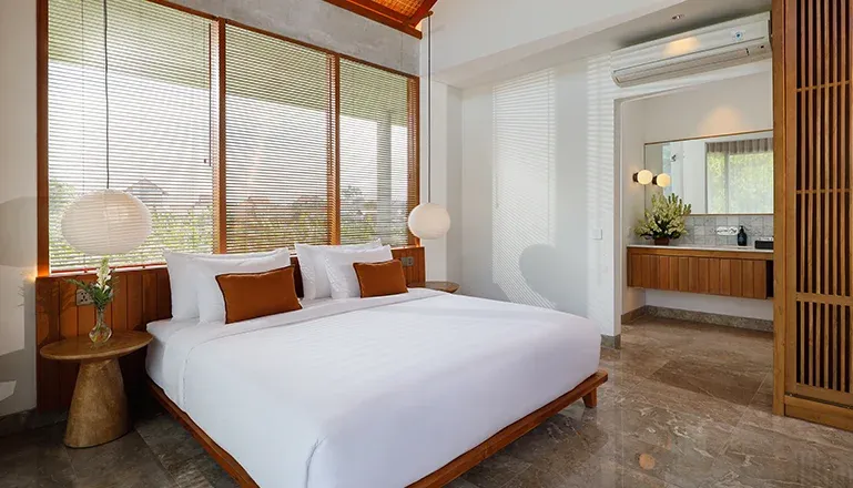 Beautifully designed bedroom with a plush king bed and closet at Villa Uma Santai