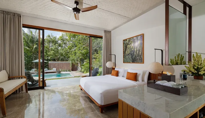 Luxurious Bali master bedroom with pool view and elegant decor