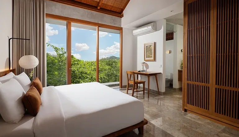 Luxurious Bali villa bedroom featuring a comfortable work area at Villa Uma Santai