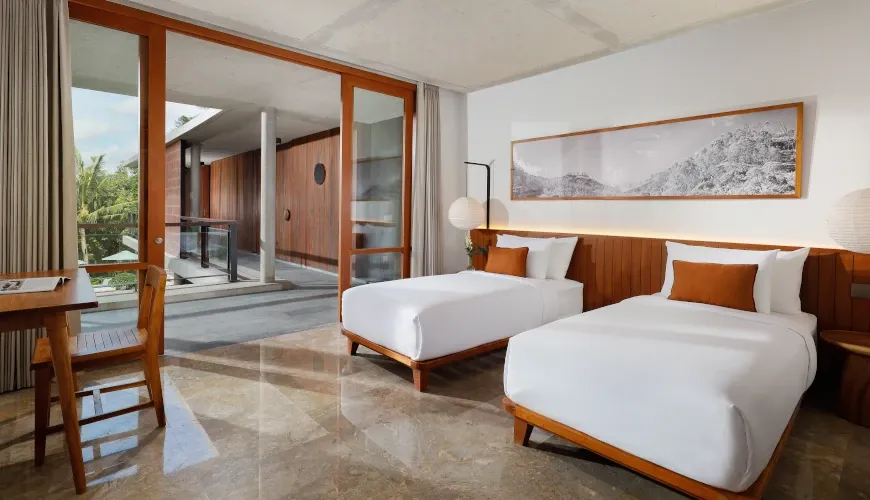 Elegant twin bedroom with marble floors, balcony access at Villa Uma Santai Pererenan