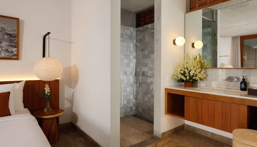 Luxury en-suite bathroom with marble shower and modern sink at Villa Uma Santai Pererenan
