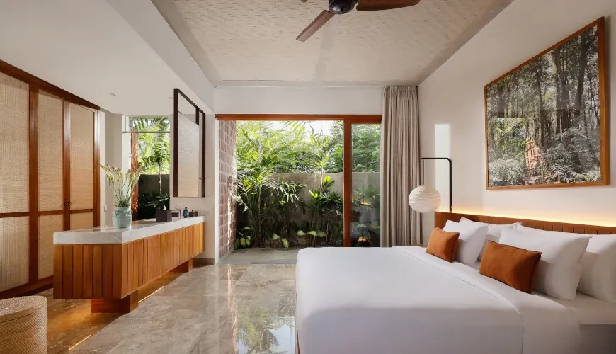 Modern bedroom with marble floors, patio view at Villa Uma Santai Pererenan
