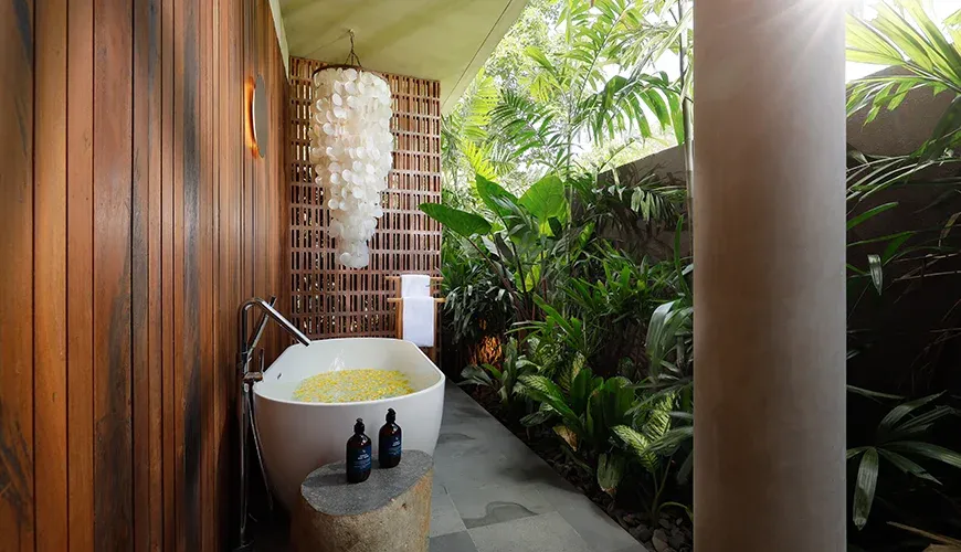 Serene bathroom with a soaking tub and tropical view at Villa Uma Santai