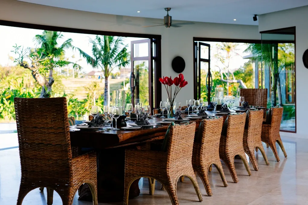 Elegant dining table for twelve overlooking a tropical Balinese garden at Villa Umah Daun