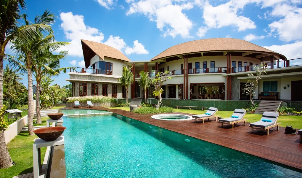 Luxury villa with a private swimming pool, sun loungers, and lush garden at Villa Umah Daun
