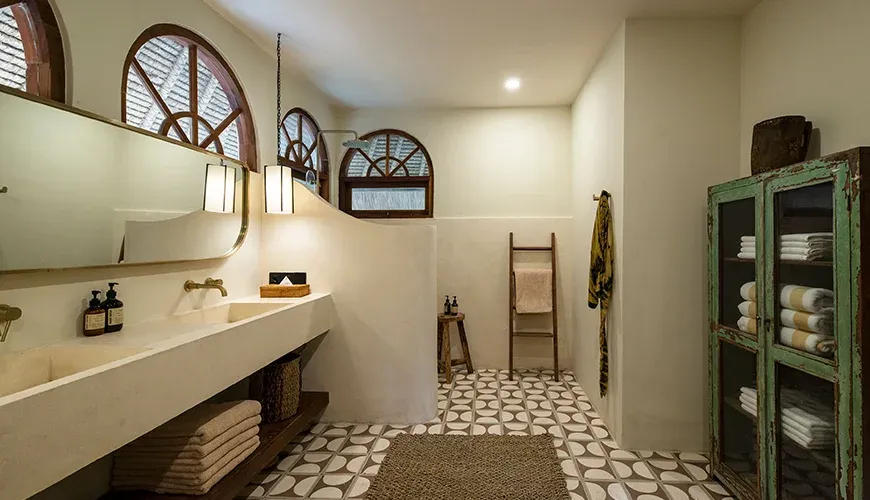 Stylish bathroom with an open shower and natural stone elements at Villa Xanadu