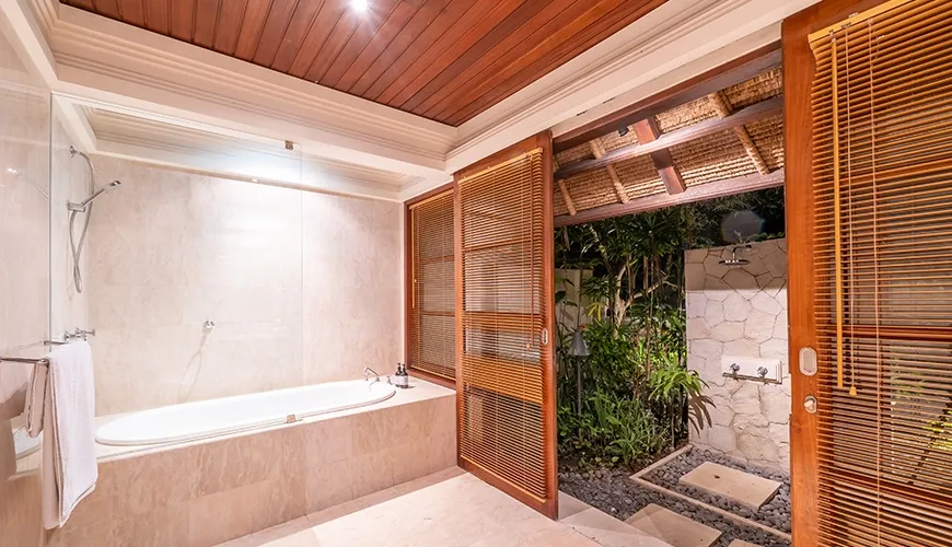 Modern bathroom with bathtub and open-air shower area at Villa Yasmine