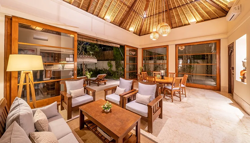 Open living dining space with traditional roof and pool view at Villa Yasmine