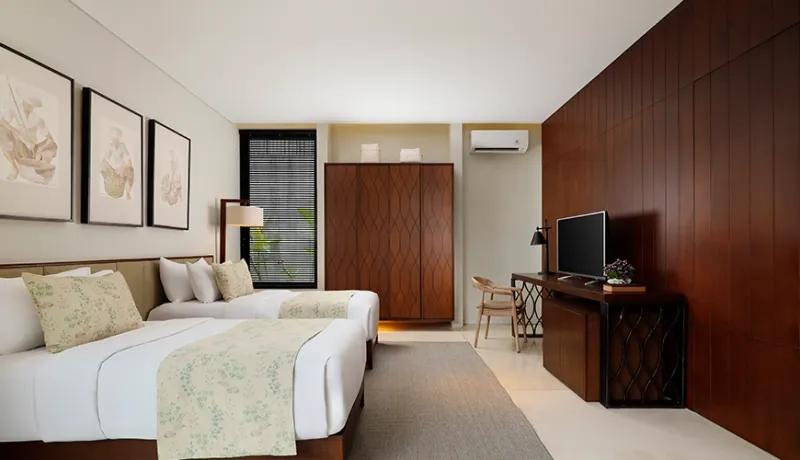 Modern twin bedroom with two comfortable single beds and a wooden work desk at Vinila Villas Duplex