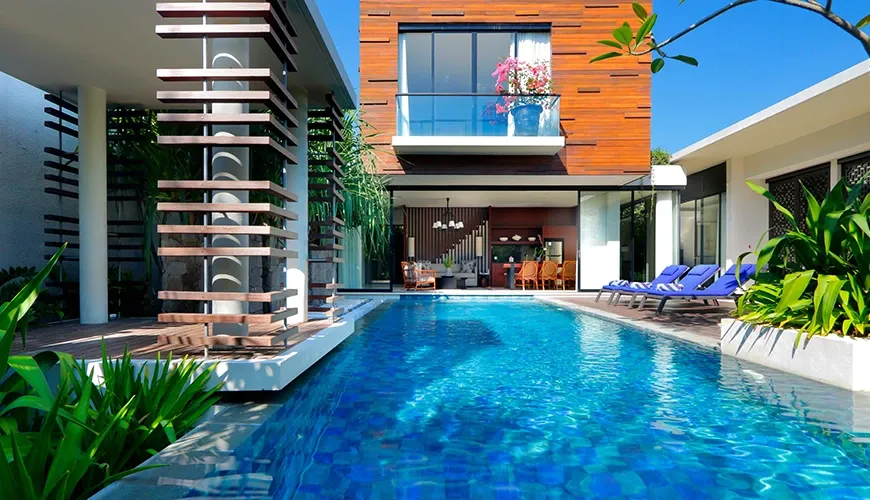 Luxury Bali villa with private swimming pool and lounge chairs at vinila villas