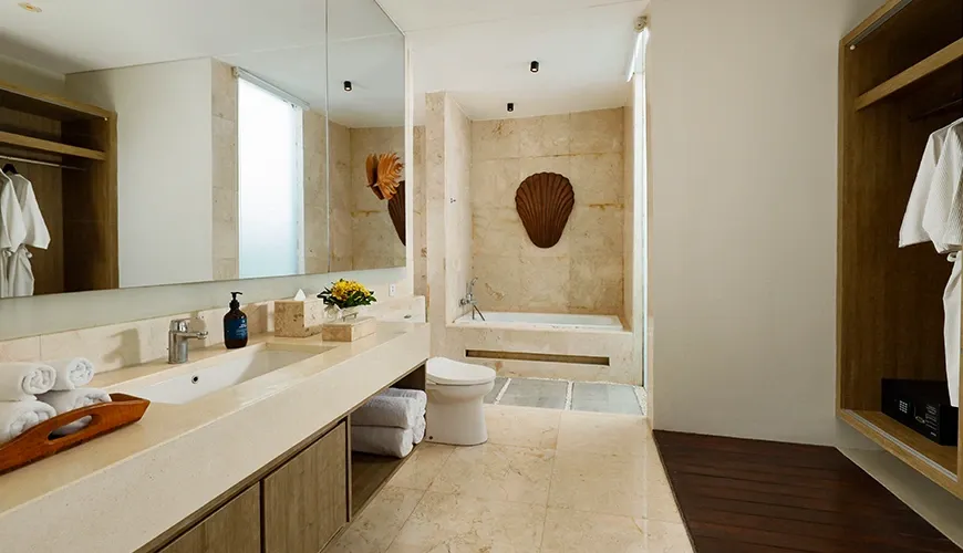 Luxury Balinese bathroom with a double vanity and bathtub at vinila villas