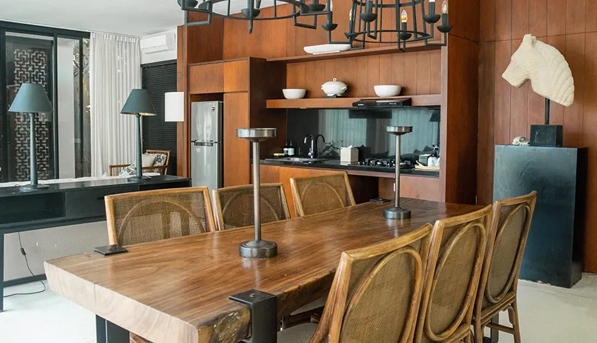 Luxury dining room with wooden table and Balinese decor at vinila villas