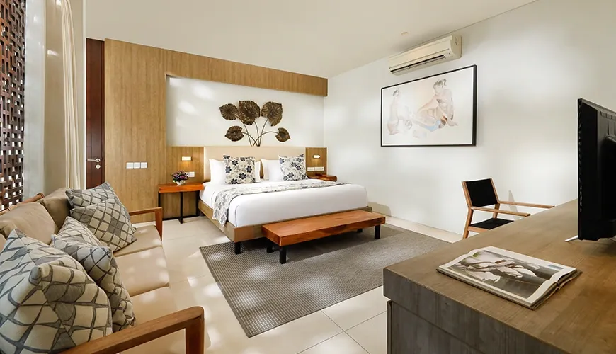 Modern Bali villa bedroom with a couch and television at vinila villas