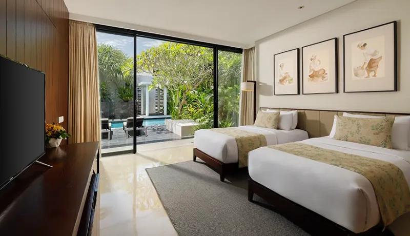 Modern twin bedroom with two single beds and sliding glass doors opening to a private pool at Vinila Villas Suite